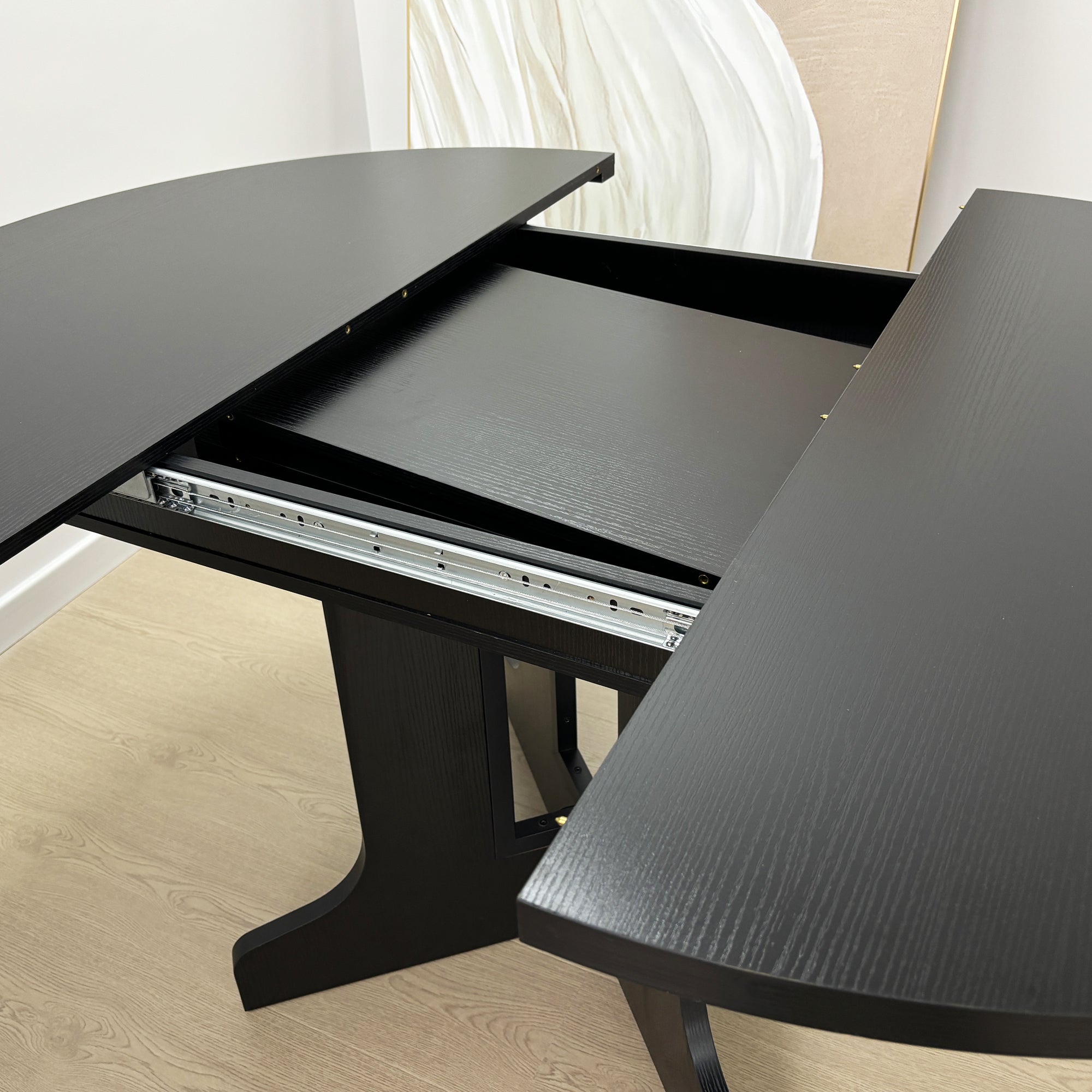Close-up of the separated black table with the slide rail and X-base exposed