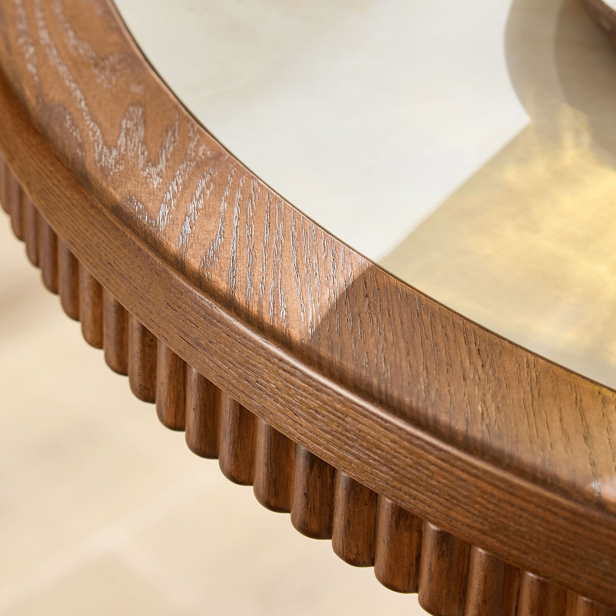Close-up of the walnut edge and inlaid white stone top of the round table