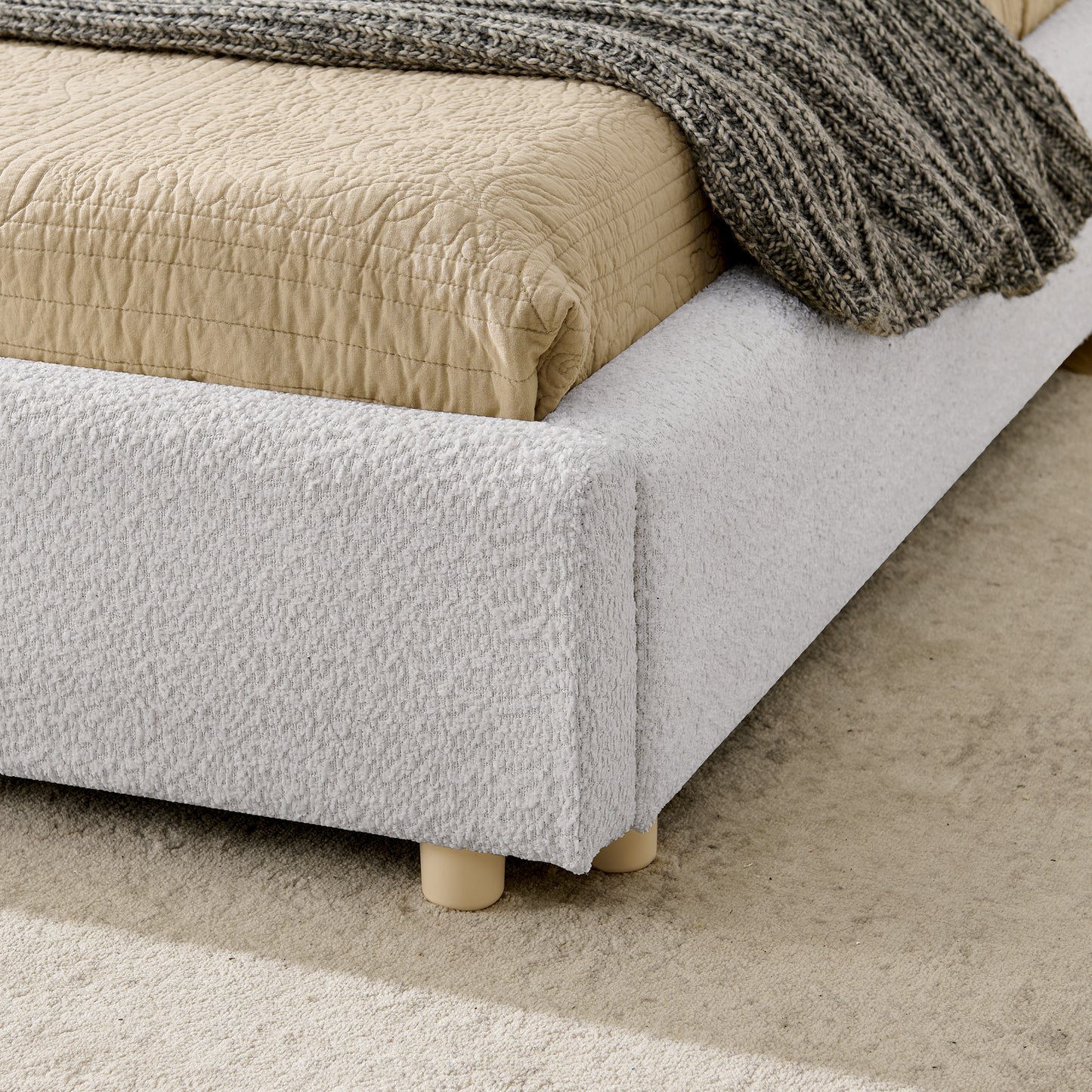 Close-up of upholstered frame corner and wood leg on carpet