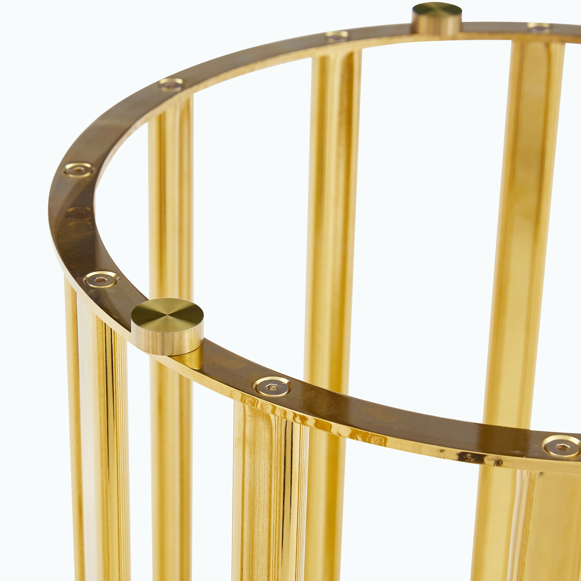 Close-up of the top of a gold column base showing the metal suction cup fasteners