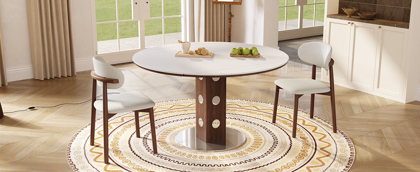 White round folding table with two cream chairs, macarons and apples by tall windows
