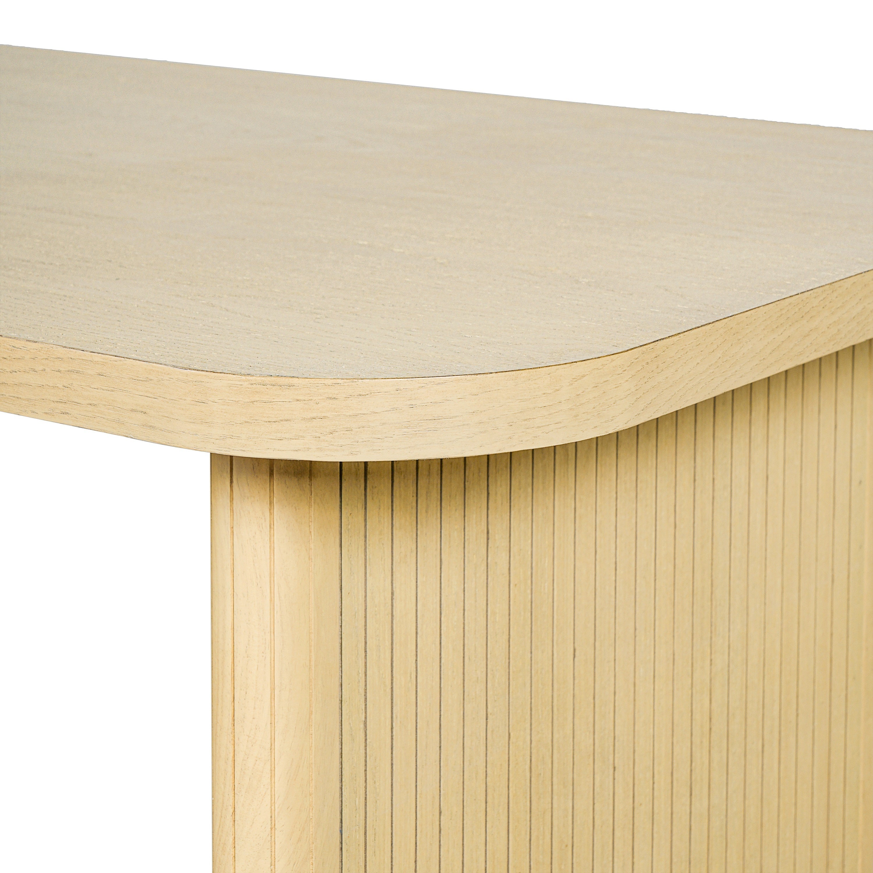 Close-up of the rounded corner and fluted leg of the natural oak dining table