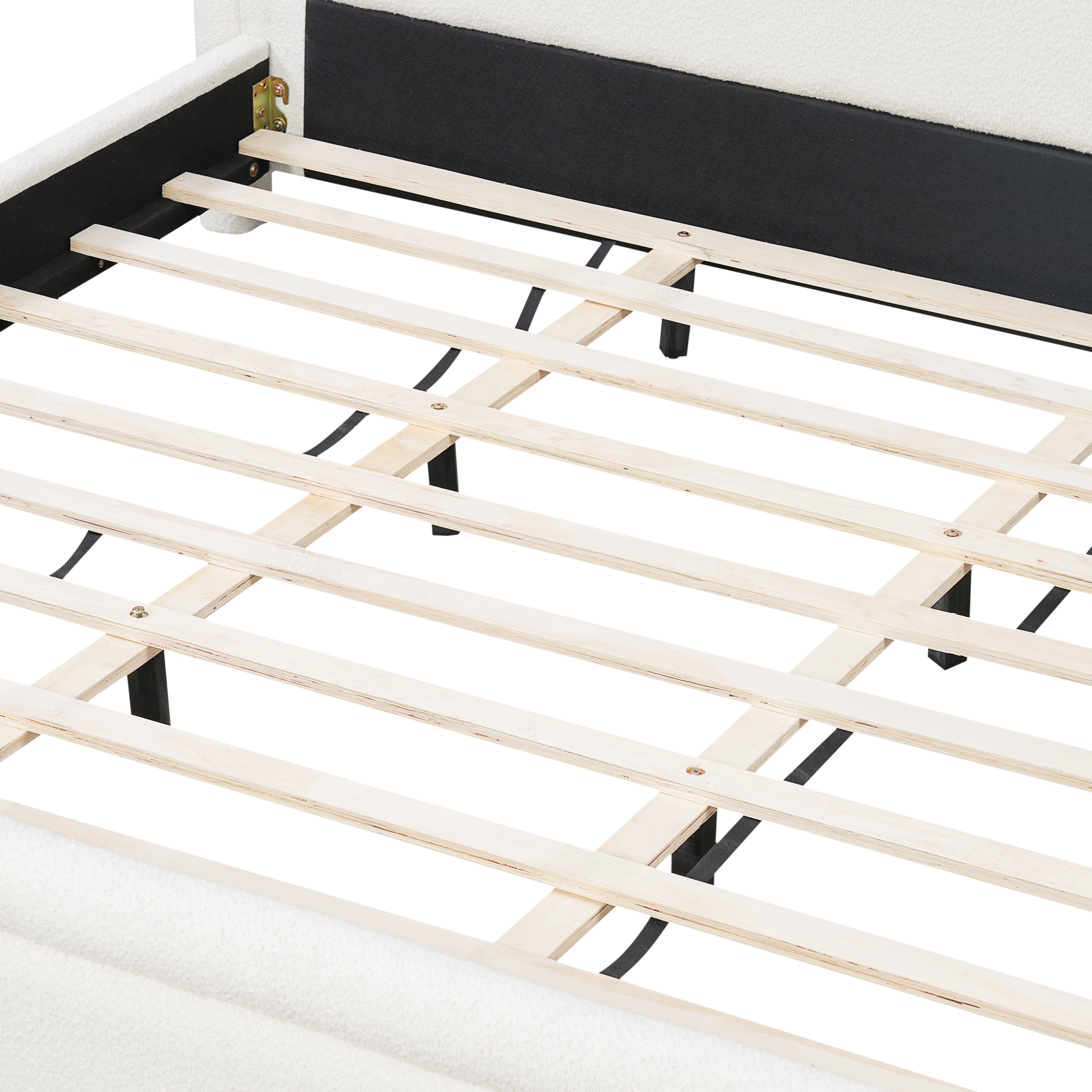 Overhead close-up of wood slat support system on boucle bed frame