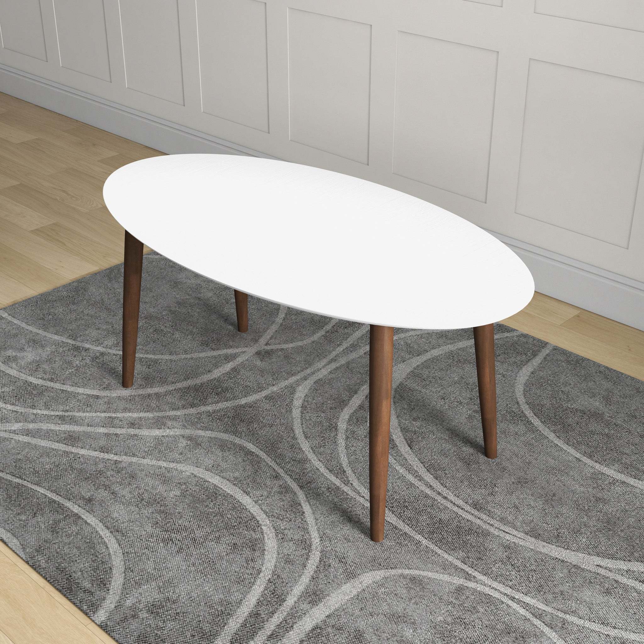 Overhead angled view of the white oval dining table in a styled room