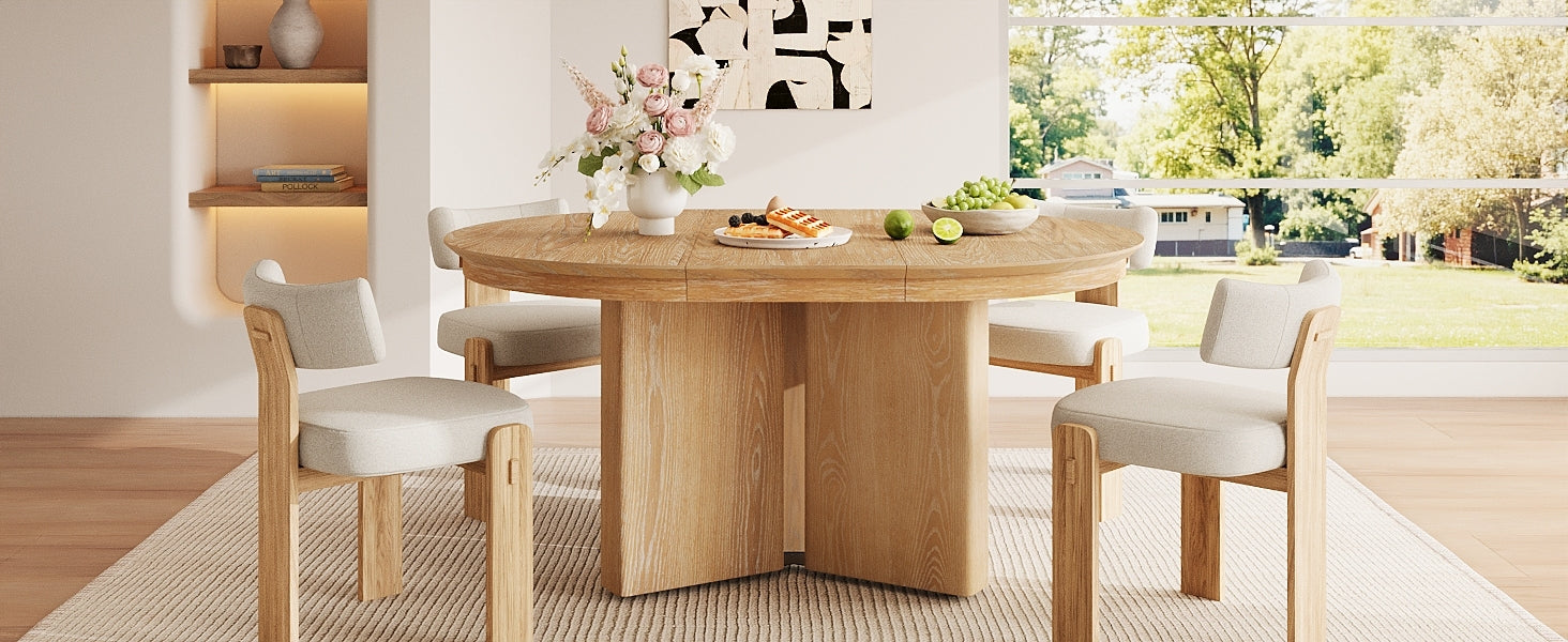 Extended oval natural oak farmhouse table with four cream chairs by a large window