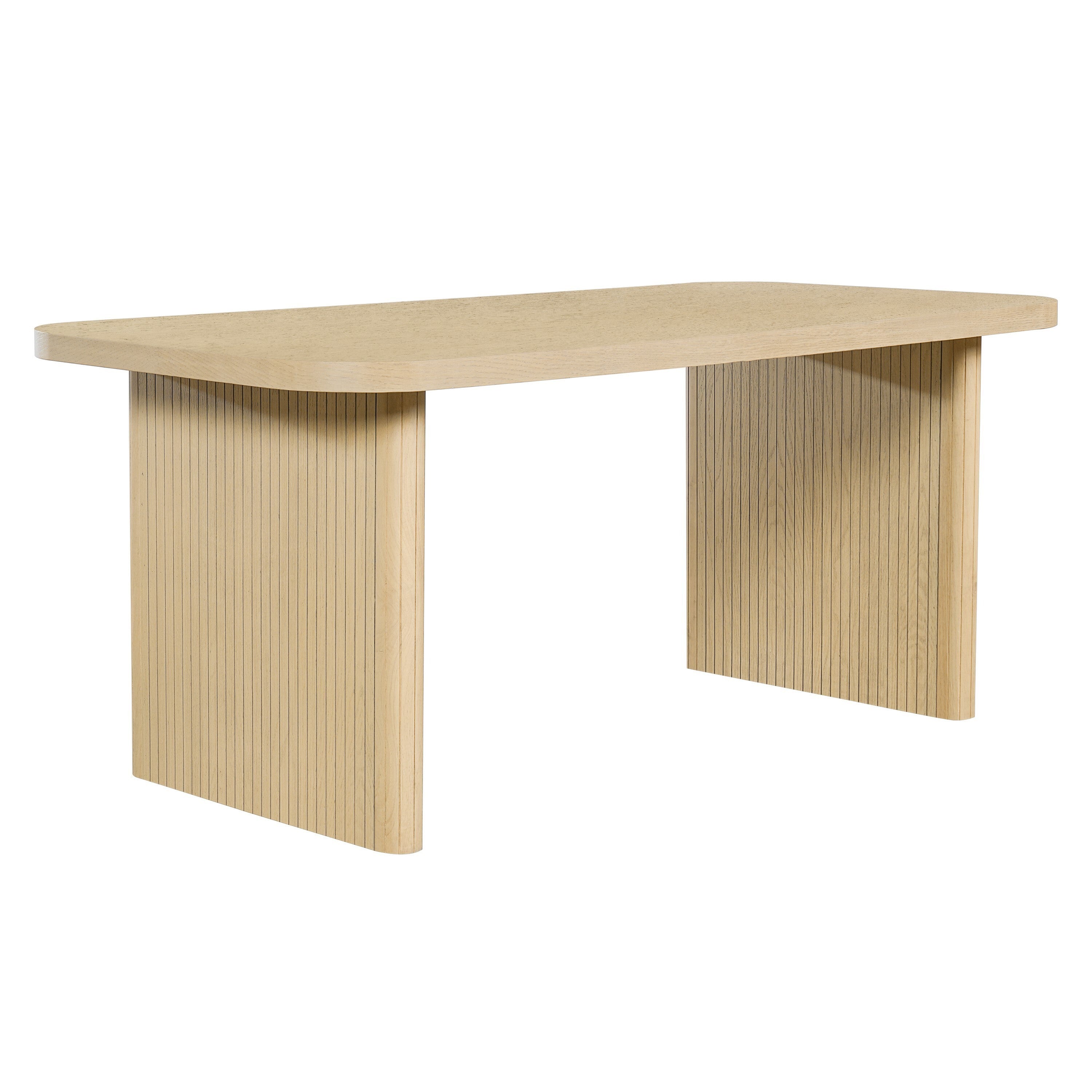 Angled three-quarter view of the oak dining table with fluted panel legs, plain white studio