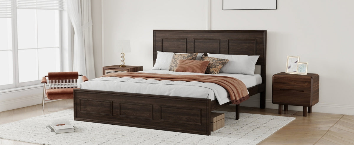 Angled view of rich brown wood queen bed with rust bedding, nightstands and chair