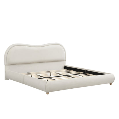 Close-up of round wood leg and upholstered corner on beige bed frame