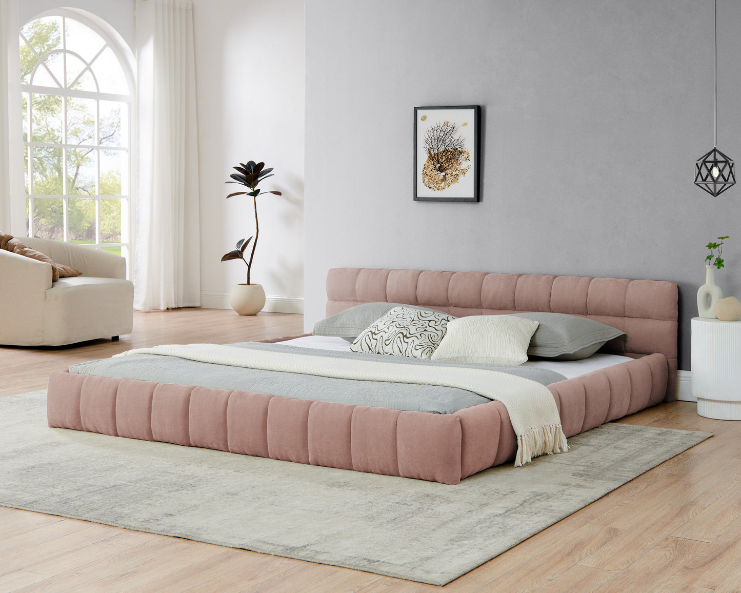 Pink upholstered king bed frame, front angle view in a modern bedroom setting