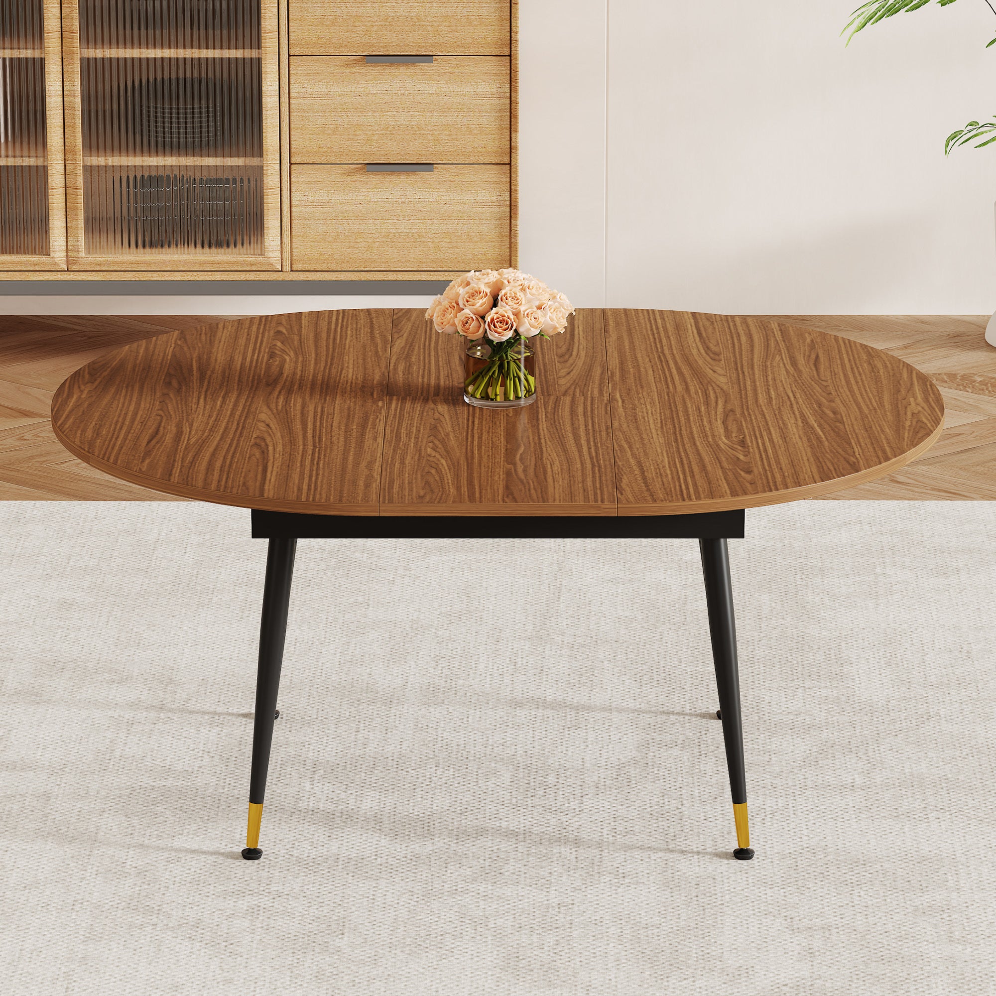 Angled overhead of the walnut oval extendable table with roses, sideboard and plant behind