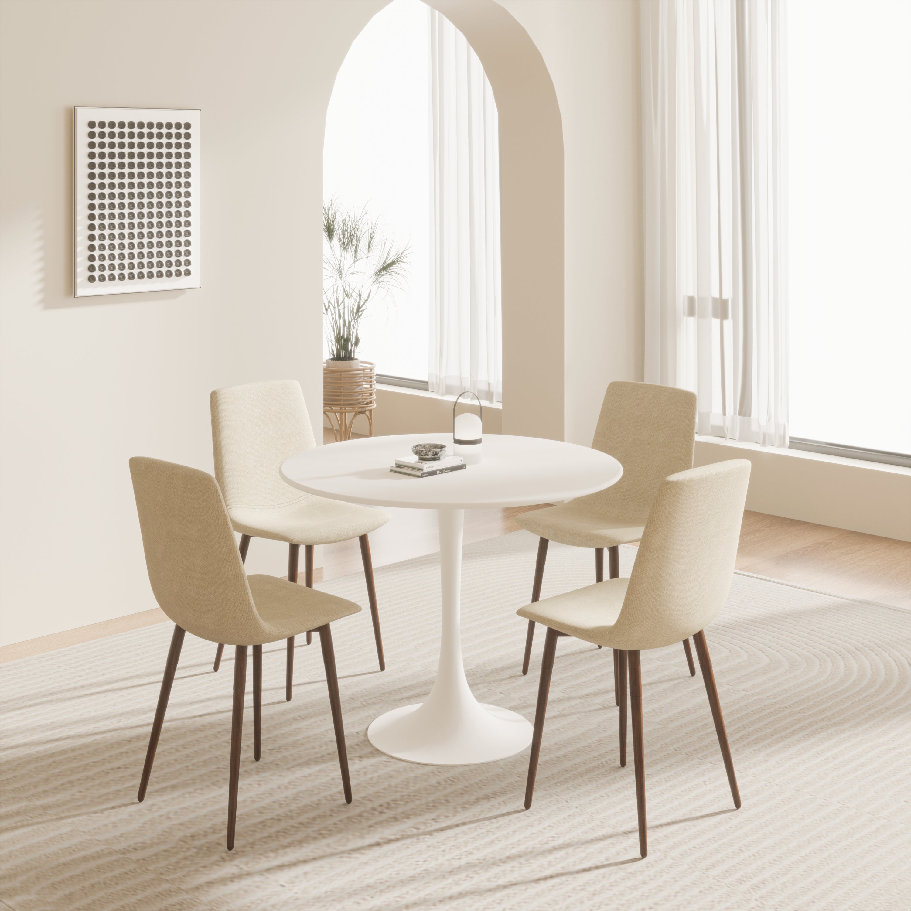White tulip dining table with four beige upholstered chairs in a bright dining room