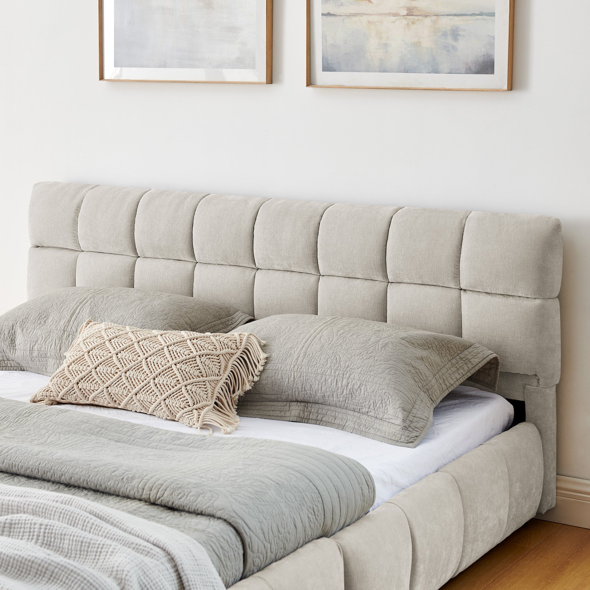 Close-up of the grid-tufted beige chenille headboard and channel-tufted rail on the queen bed