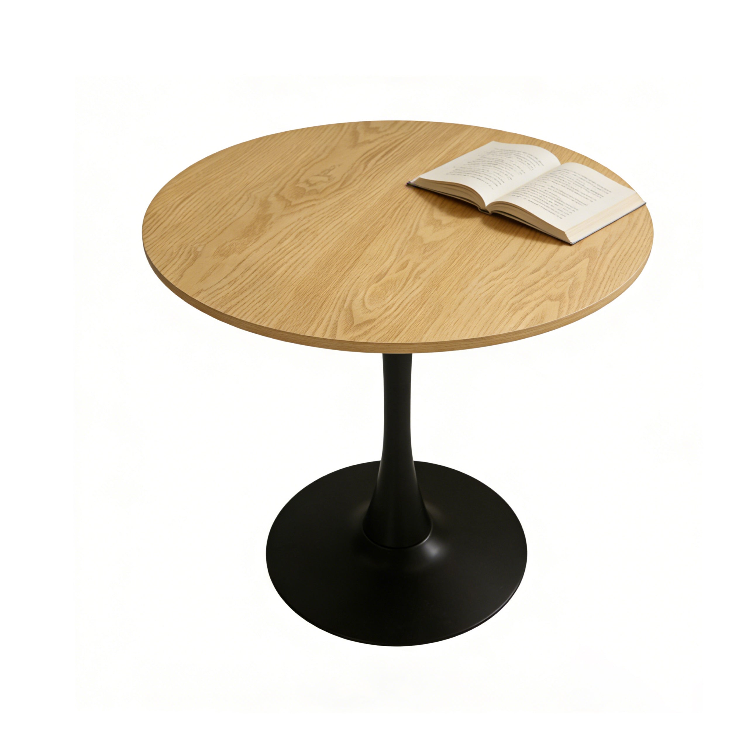 Natural round pedestal dining table on a plain white studio background with an open book on top