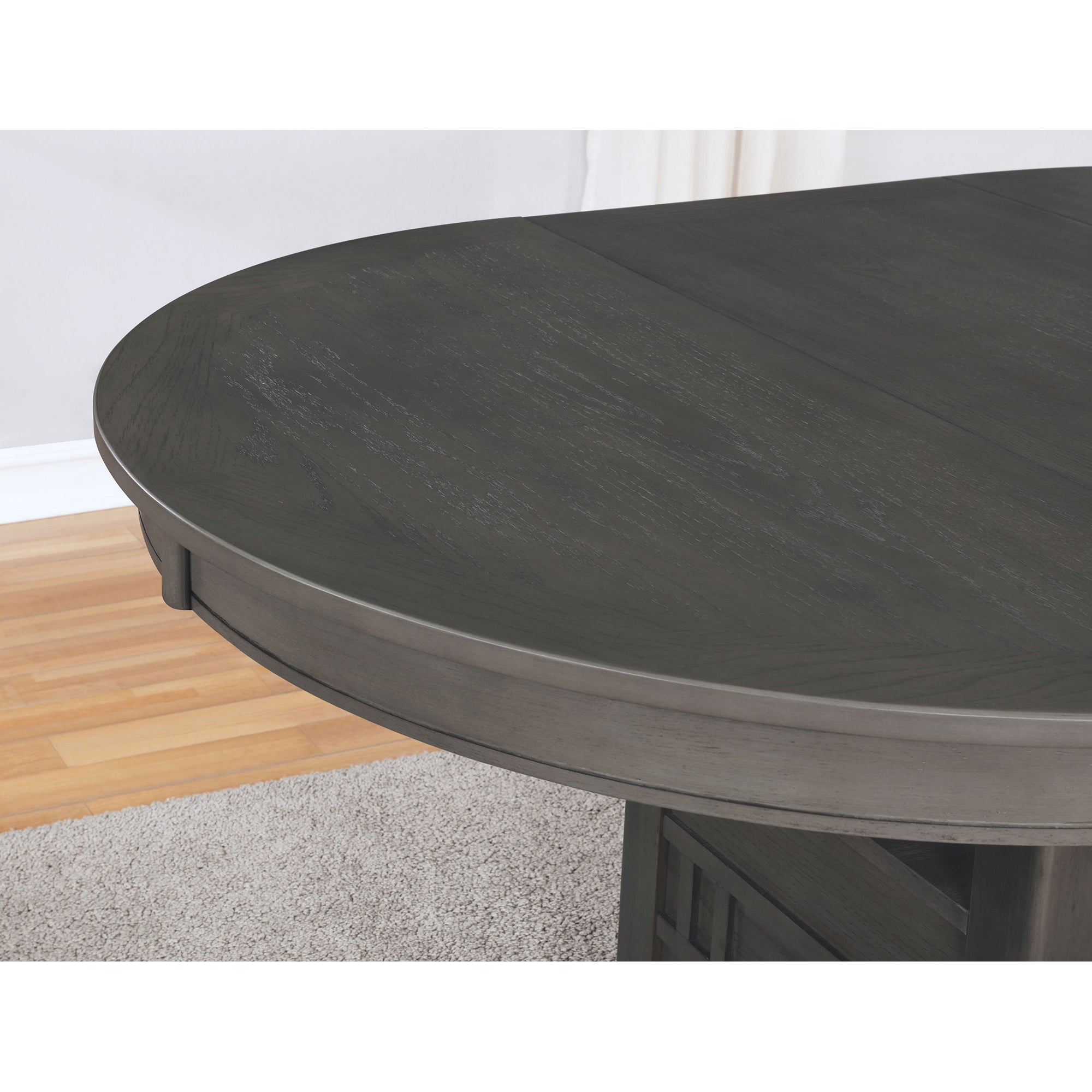 Close-up of the grey oval tabletop edge in a room setting