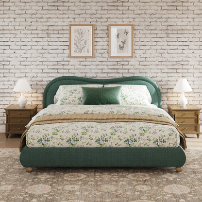 Olive green king bed in farmhouse-style bedroom with brick wall