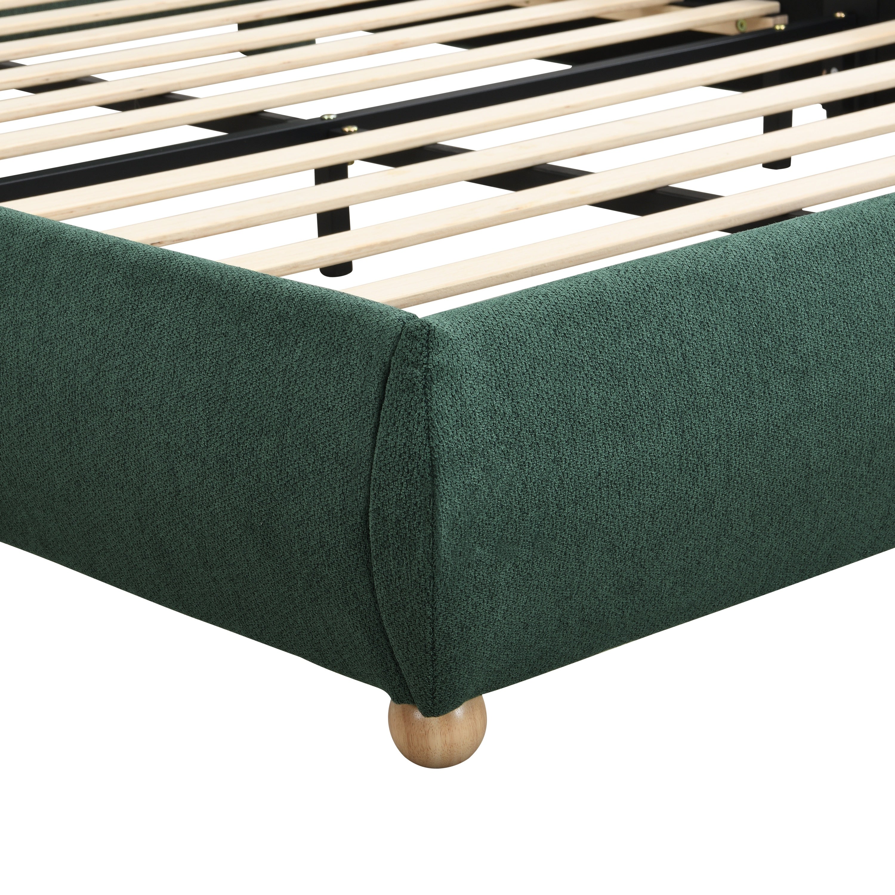 Close-up of upholstered corner and round wood leg on olive bed frame