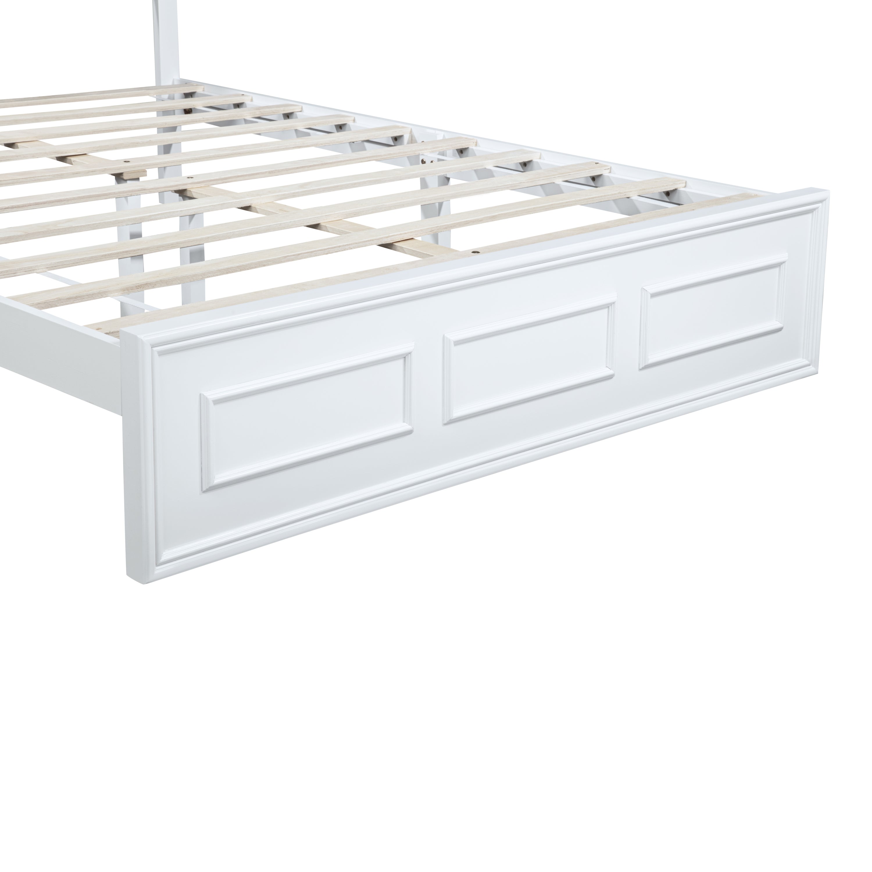 Angled view of the framed raised-panel footboard and wood slats on a white queen bed #Color_White
