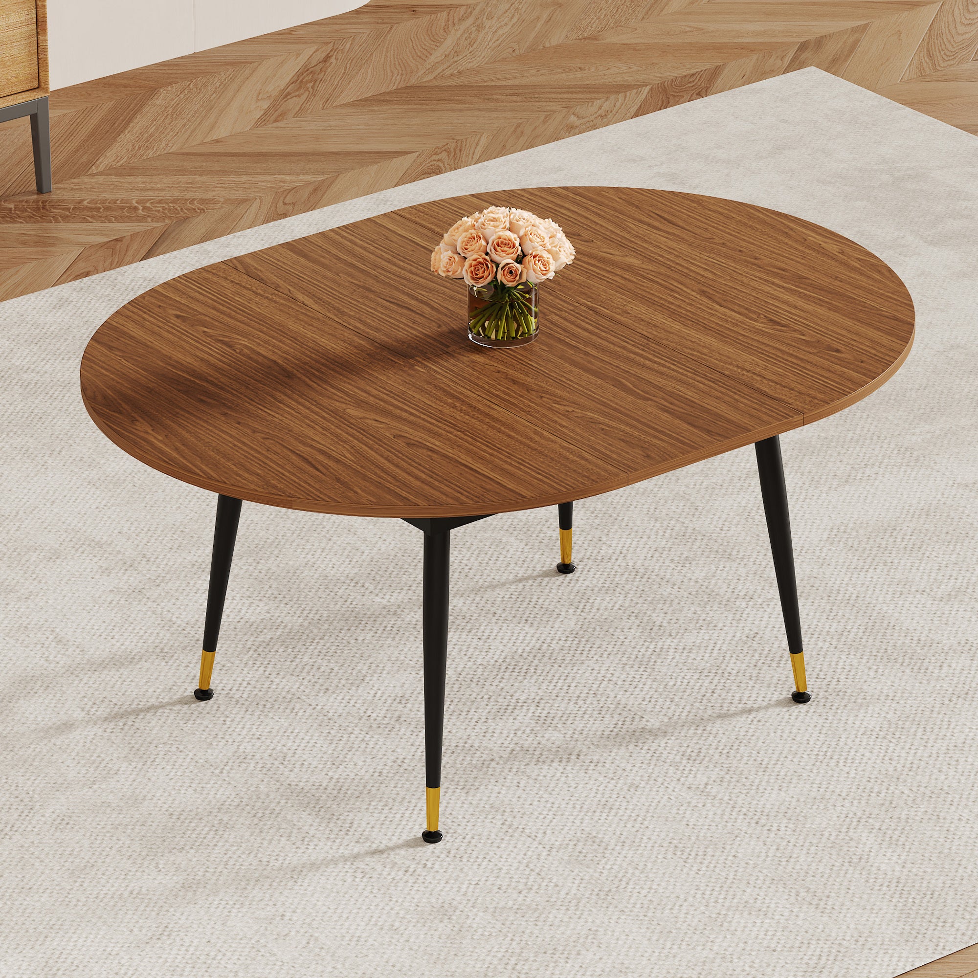 Three-quarter view of walnut oval extendable dining table with roses beside a wood sideboard