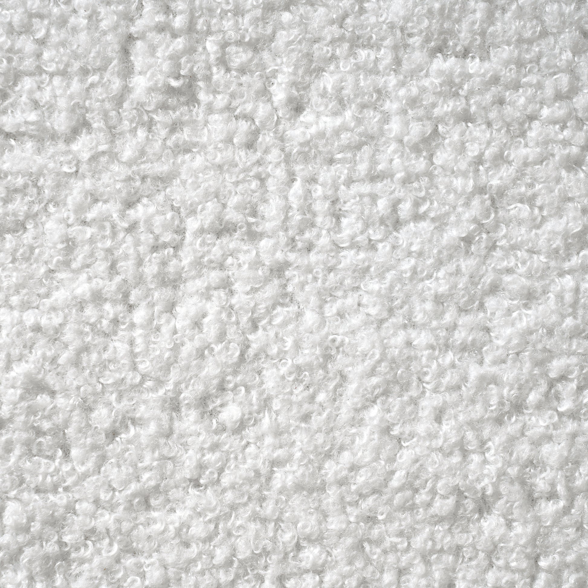 Angled view of white bouclé king bed frame showing enclosed wood base