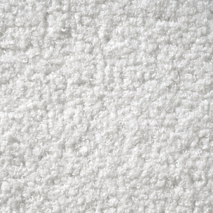 Angled view of white bouclé king bed frame showing enclosed wood base