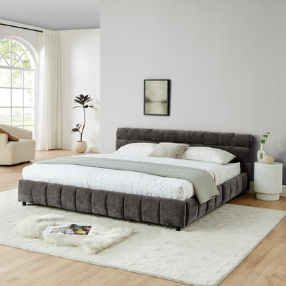 Dark gray chenille king bed frame in bedroom with fringe rug