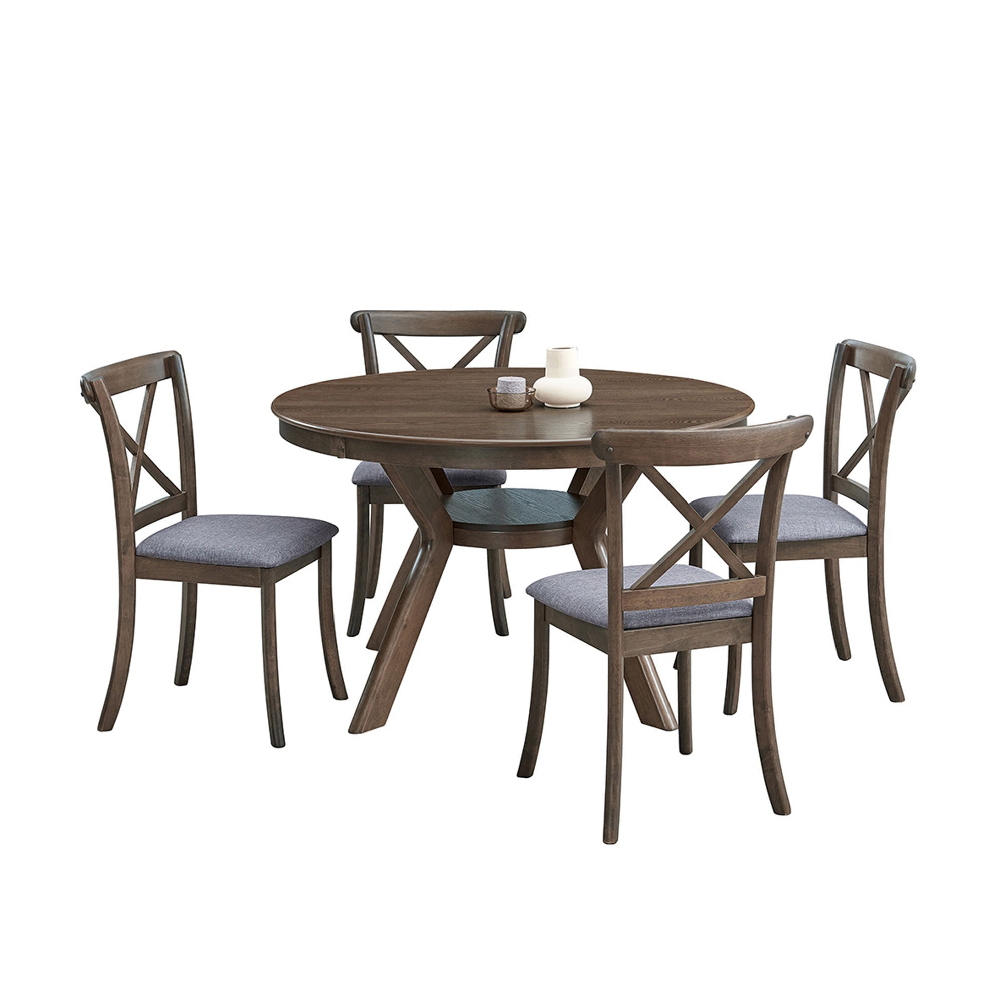 Round oak dining table with four cross-back chairs, angled studio view with white decor