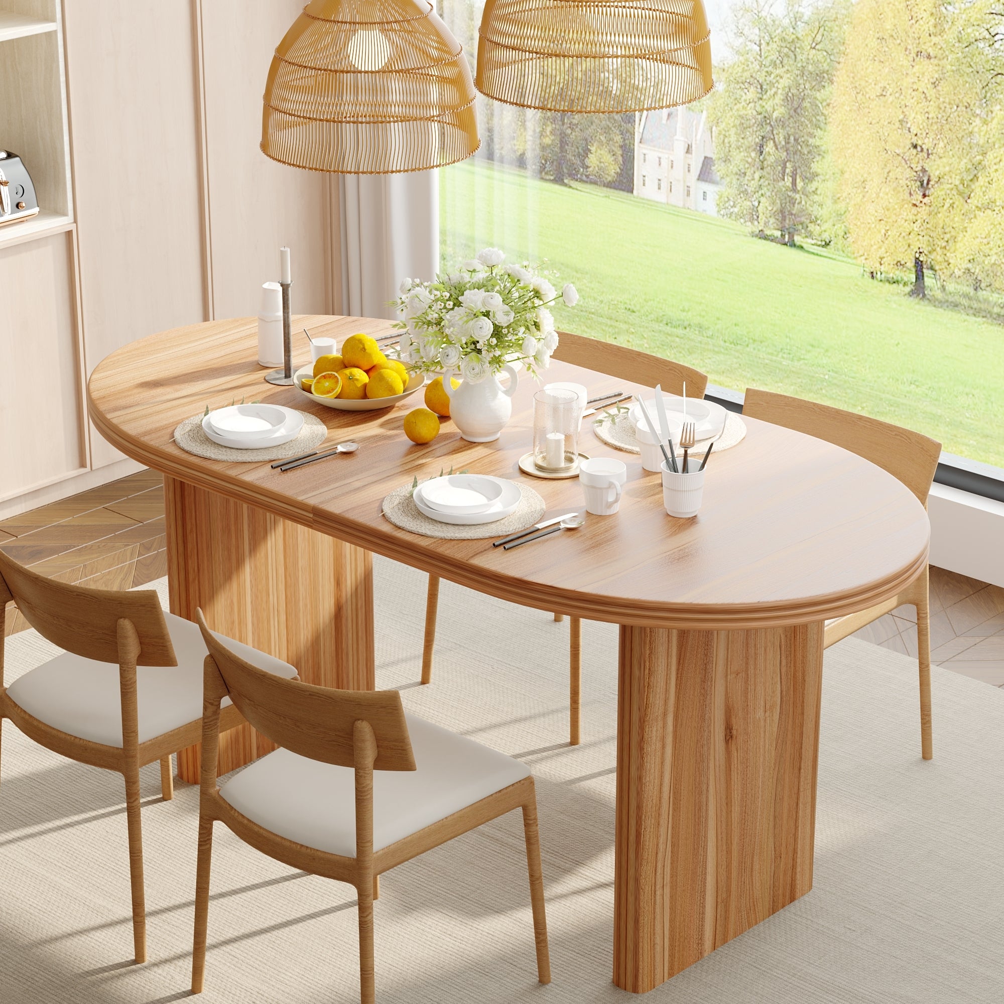 Close three-quarter view of the natural wood oval table set with plates, lemons and flowers