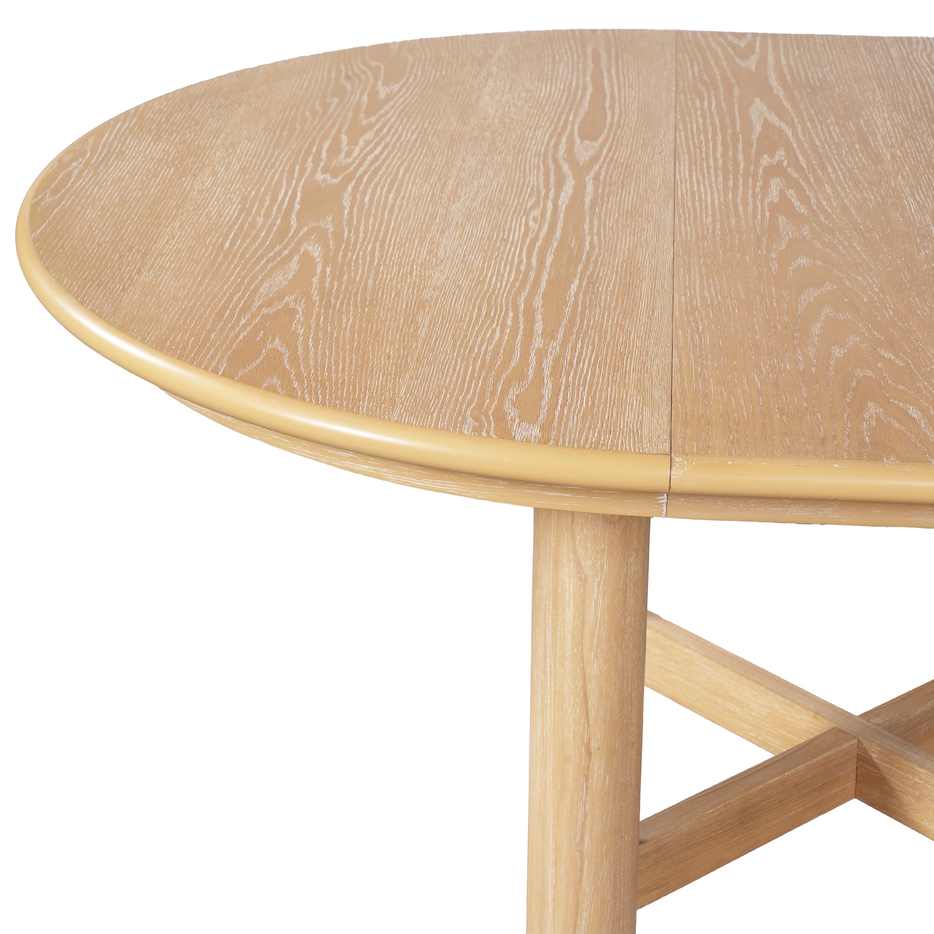 Three-quarter studio view of the closed round oak-veneer table