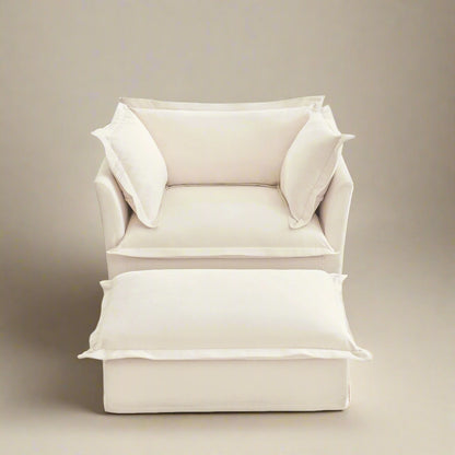 studio shot of the big fluffy chair in chenille cream with ottoman showing the plush rich texture of the chenille upholstery the wide deep seat and plush cushions.