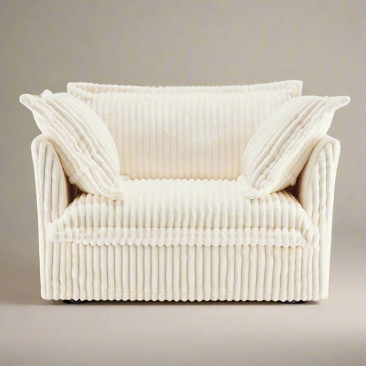 studio shot of the fluffy chair in cream corduroy showing the rich texture and color as well as the plush pillows and wide deep seat