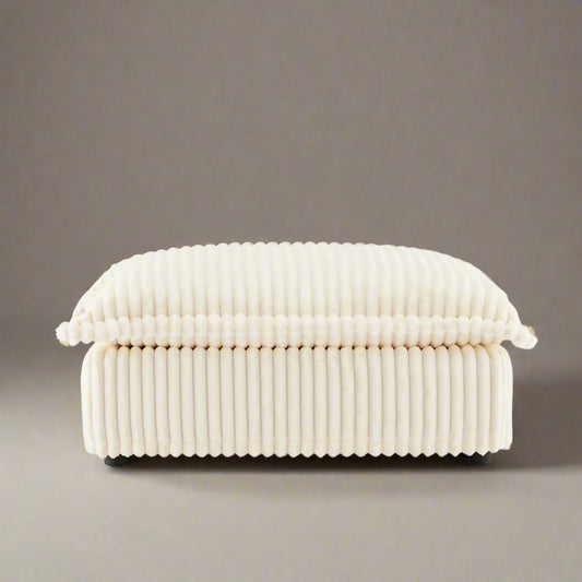 studio shot of the fluffy ottoman in cream corduroy showing the ridged luxurious texture of the corduroy upholstery and plush seat