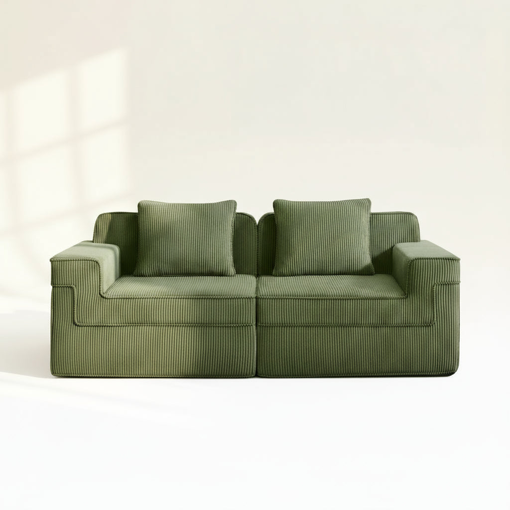 studio shot of the green boneless couch in olive corduroy showing wide armrests deep seats and plush corduroy upholstery