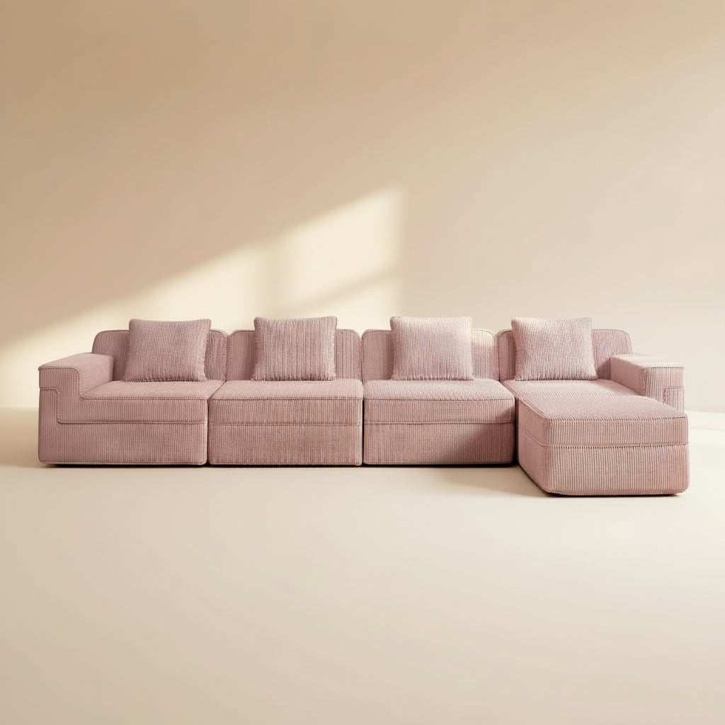 studio shot of the boneless couch in pink showing the rich corduroy fabric comfortable deep seats four seats and ottoman