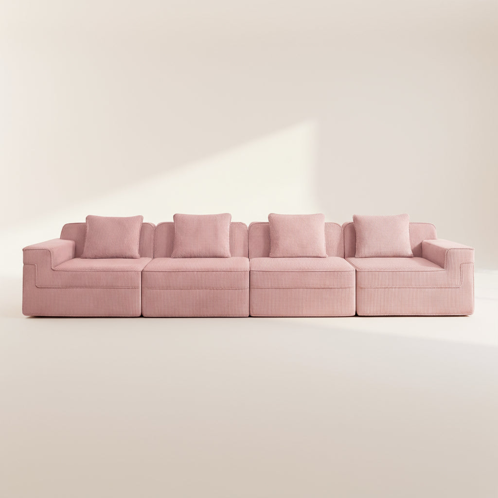 commercial photo of the pink boneless couch with four seats showing the comfortable deep seats plush pillows and rich texture of the corduroy upholstery
