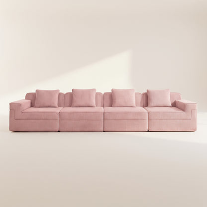 commercial photo of the pink boneless couch with four seats showing the comfortable deep seats plush pillows and rich texture of the corduroy upholstery