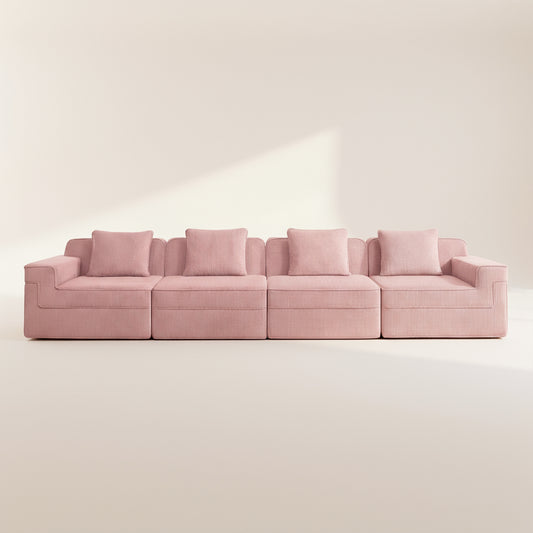 commercial photo of the pink boneless couch with four seats showing the comfortable deep seats plush pillows and rich texture of the corduroy upholstery