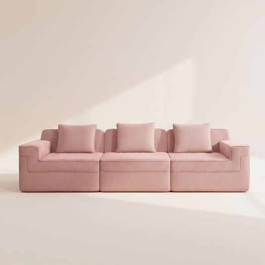 commercial photography of the boneless couch in pink showing the rich corduroy texture and comfortable three seat modular sectional