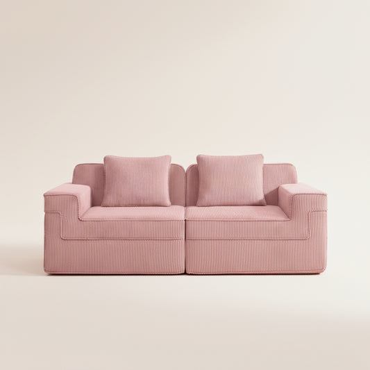 commercial studio photograph of the boneless couch in pink showing the plush corduroy fabric deep seats and two pillows