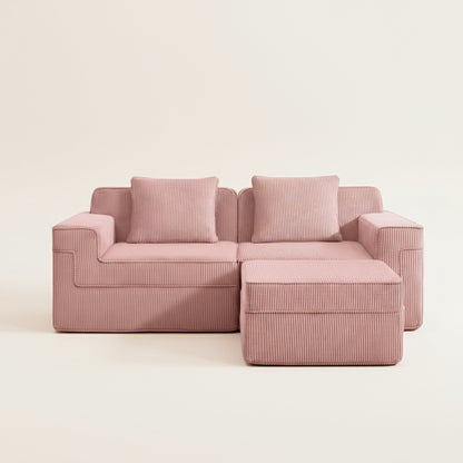 studio shot of the boneless couch in pink corduroy showing the details texture and comfort as well as the deep two seat modularity and ottoman