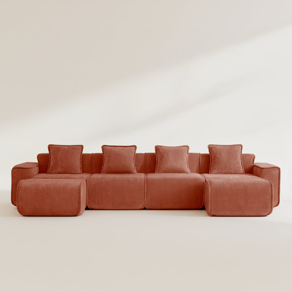 studio shot of the seneca boneless couch four seater with two ottomans in terracotta velvet