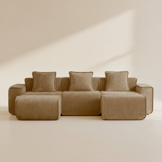 studio shot of the seneca boneless couch in mocha velvet showing three seats and two ottomans
