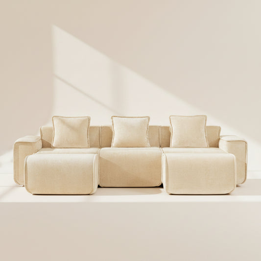 studio shot of the seneca boneless couch with three seats two ottomans in camel