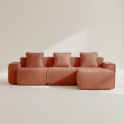 studio shot of the seneca boneless couch with three seats and one ottoman in terracotta