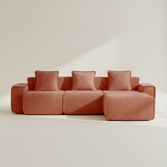 studio shot of the seneca boneless couch with three seats and one ottoman in terracotta