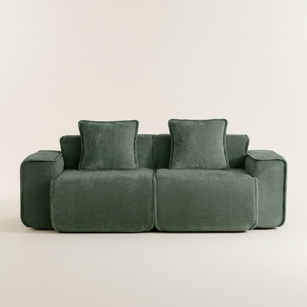 Green sofa with cushions on a white background