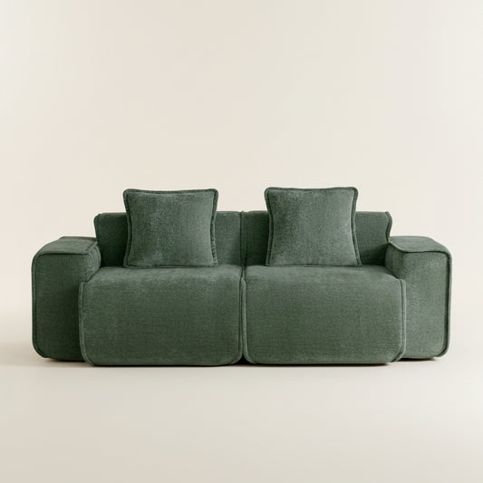 Green sofa with cushions on a white background