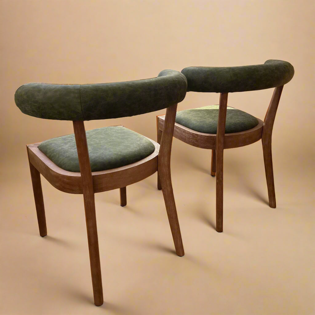rear view of solid wood dining chairs with green vegan leather seats and backrests for circular dining table