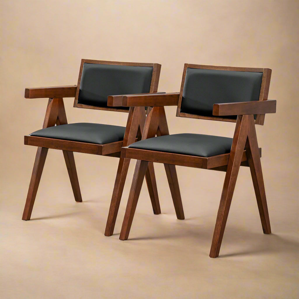 quarter profile image of solid wood and black vegan leather dining chairs showing subtle silhouettes