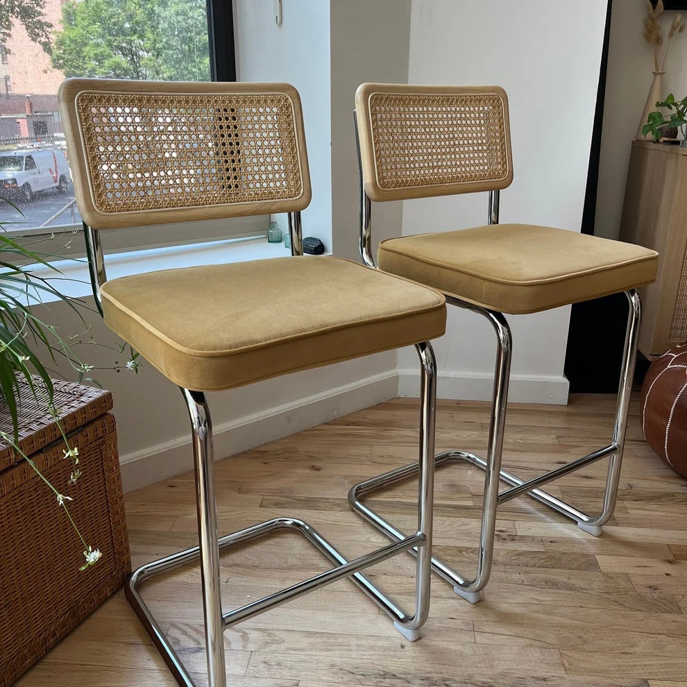 front view showing yellow velvet seats on counter height bar stools with 26 inch seat height and solid wood natural rattan seat backs